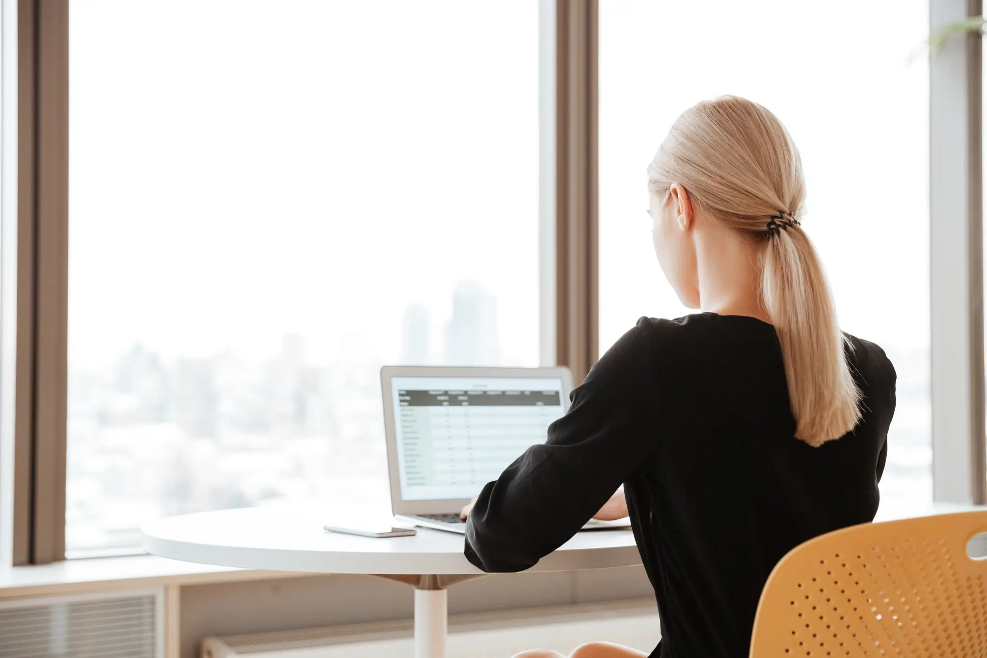 Image of a woman working on a laptop